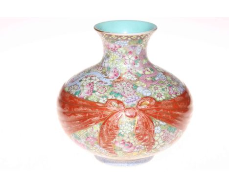 Chinese porcelain vase of onion form with iron red and gilt bow tied sash on profusely decorated ground with dragons and flow