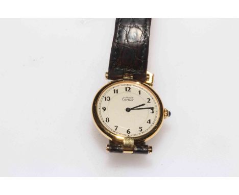 Cartier de Must silver gilt ladies wristwatch with leather strap, serial no. 590003030005, boxed and with papers.