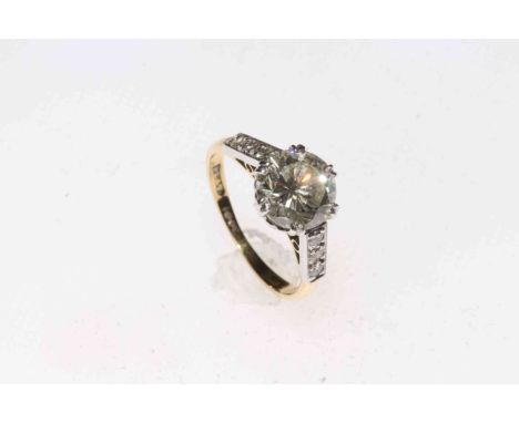 Two carat plus solitaire diamond ring with brilliant shoulders set in 18 carat gold and platinum, size K/L.