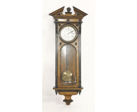 A walnut 'Vienna regulator' wall clock, with ebonised details, an architectural cornice, enamel dial and a single train weigh