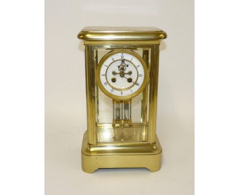 An Edwardian brass four glass mantel clock, with an enamel dial and mercury pendulum, 35cm high