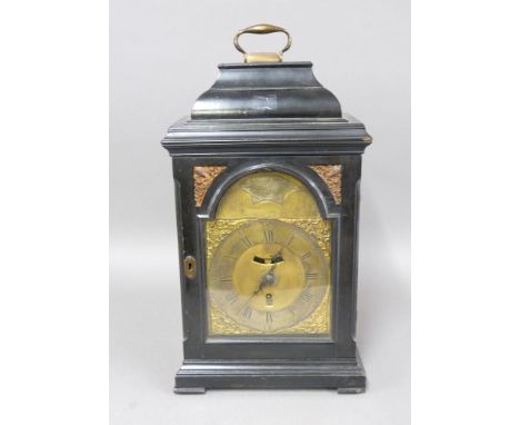 An 18th century ebonised bracket clock, the arched brass dial with engraved scene of a naval battle, inscribed 'Mandevill Som