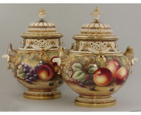 A pair of Royal Worcester massive urns and covers, decorated with fruit, by J Skerrett, with pierced collars and swags, print
