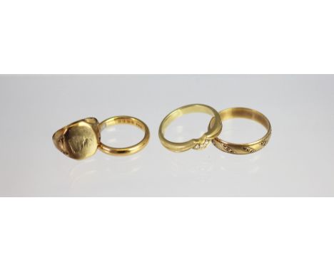 A 22ct yellow gold wedding band, weight 4.2gms, a 9ct yellow gold band and a 9ct gold signet ring, weight 3.5gms and an 18ct 