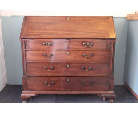 A George III mahogany bureau, with fall enclosing a fitted interior, above two short and three long drawers, on ogee bracket 