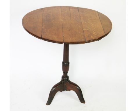 A golden oak drop leaf dining table, 76cm H, with a George III oak tripod table (reduced), an oak fire curb and an oak drop l