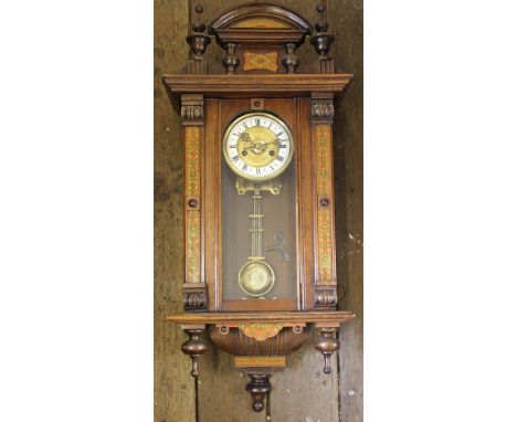 A walnut Vienna regulator clock, with enamel Roman numeral chapter ring and movement striking on a gong, in architectural cas