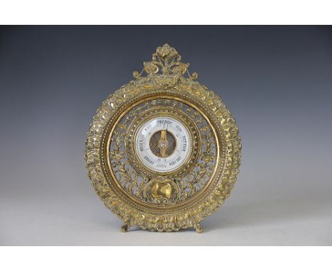 A Victorian pierced cast brass aneroid barometer, with elaborate circular frame, 30cm