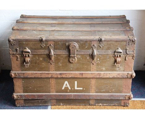 A vintage wooden and metal bound trunk, with internal tray and canvas interior, stamped 'A L', with lock  and two leather han