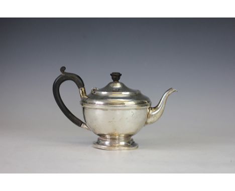 A silver teapot Dennison, Birmingham 1932, of circular pedestal form and with ebonised finial and handle, 15cm high, weight 1