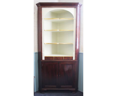 A George III and later mahogany corner cabinet, the open front with a painted interior of three shelves and three drawers, ab