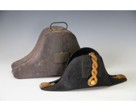 A Royal Navy officer's dress hat by Pote and Son outfitters, with gold braid, button and tassel detail and within tin carryin