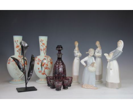 Four Lladro figures of girls, two modelled holding lambs, one holding a duck and another with kittens, smallest 22.5cm high, 