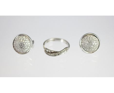 A pair of diamond set, white gold earrings, each designed as a circular convex panel, pave set with diamonds, all set in 18ct