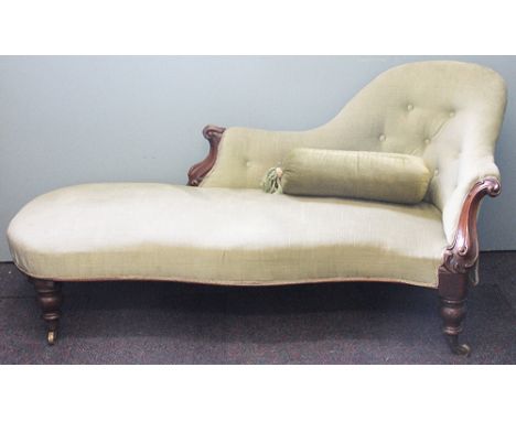 A Victorian carved rosewood spoon back chaise longue, with button back green upholstery, on turned legs 156cm 