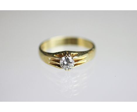 A diamond solitaire ring, the brilliant cut diamond within six claw gypsy setting, all set in 18ct yellow gold, stamped '65',