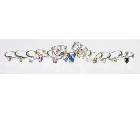 Twelve gem set silver rings, to include amethyst, garnet, peridot and topaz set examples, all set in white metal stamped '925