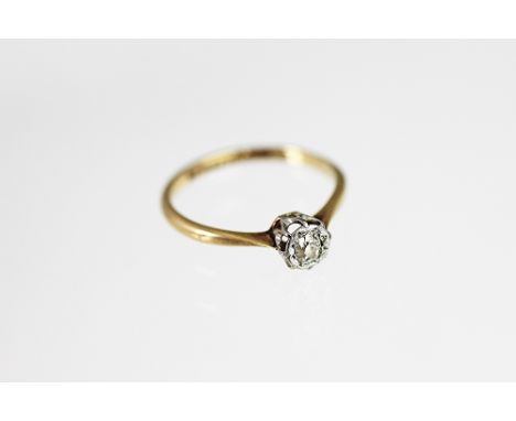 A diamond solitaire ring, the old cut diamond illusion set in white metal to the tapering shoulders and plain yellow metal ho