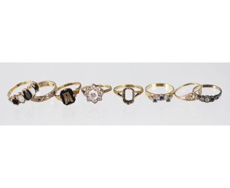 A collection of eight assorted rings, mainly set in 9ct gold, to include; a garnet and opal dress ring, a sapphire and diamon