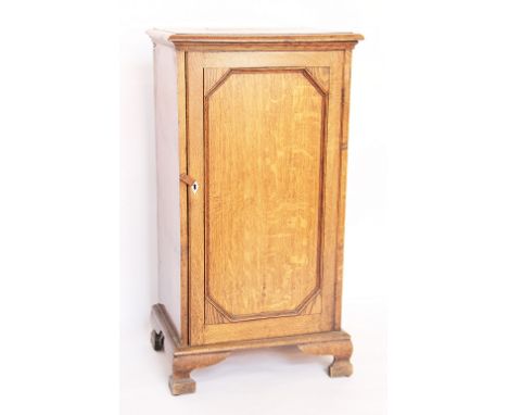 A late Victorian golden oak pot cupboard, with door enclosing shelves, on ogee bracket feet, 88cm H x 47cm W x 35cm D