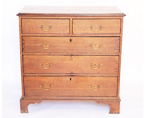 A George III oak chest, of two short and three graduated long drawers, on bracket feet, 96cm H x 95cm W x 51cm D