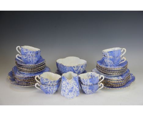 A Foley China Wileman & Co Shelley tea service, decorated in rich blue  with floral panels in Aesthetic style, below gilt rim