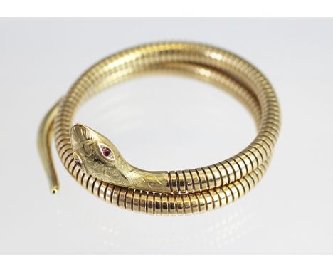 A 9ct yellow gold snake bangle, Cropp and Farr, Birmingham 1982, the articulated, coiled snake with stone set eyes, total wei