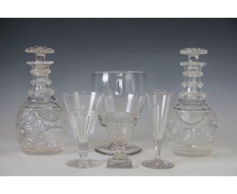 A pair of Regency Prussian form, triple ring neck decanters and mushroom form stoppers, with swag cut decoration, 25cm high (