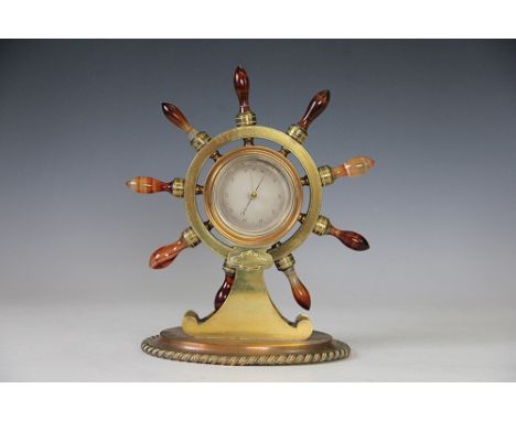 A Victorian brass ships wheel aneroid barometer, with banded orange agate wheel handles, 26cm