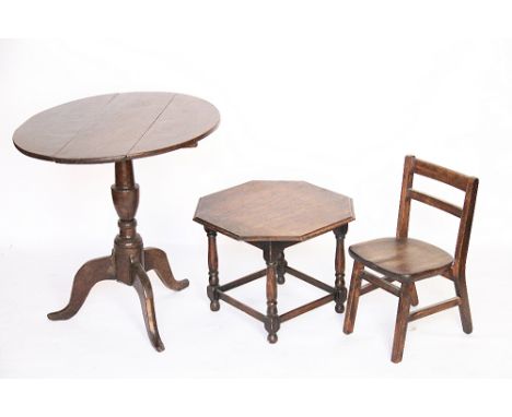 A 1920's oak octagonal wall mirror, 74cm, with an oak tripod table, circular table and child's chair (4)
