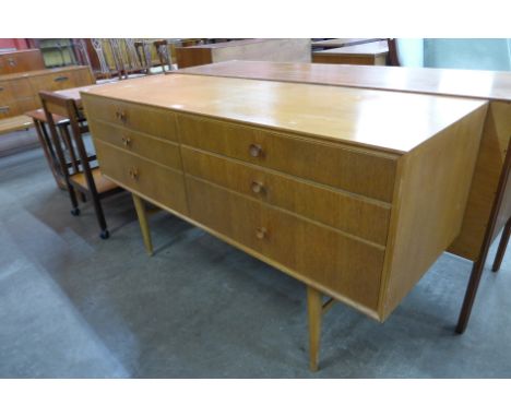 A light oak six drawer sideboard 