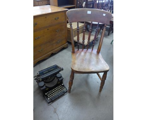 A vintage Smith Premier typewriter and a Victorian elm and beech kitchen chair 
