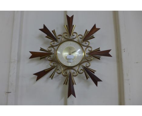 A teak and brass wall clock 