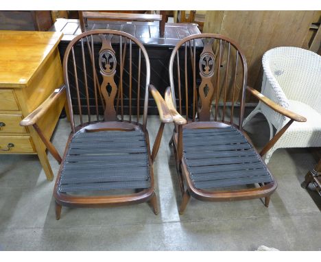 A pair of Ercol beech fleur de lys armchairs 