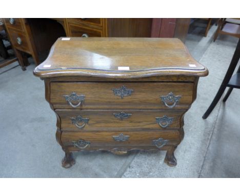 A small French style oak bombe shaped commode 