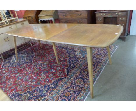 An Ercol Blonde elm and beech Grand Windsor extending dining table 