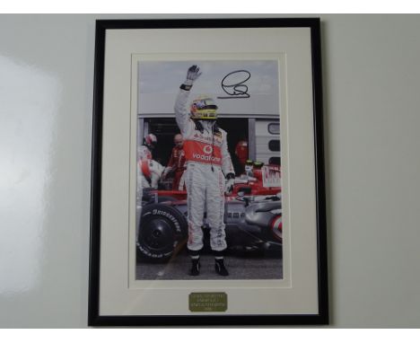 AUTOGRAPH: LEWIS HAMILTON - A framed and glazed signed colour 10 x 8 photograph - this item has been independently checked an