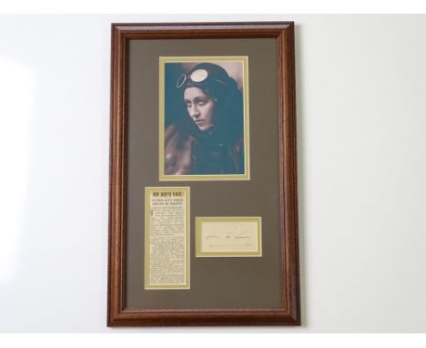 AUTOGRAPHS: AMY JOHNSON - A mounted photograph, newspaper article and signed index card - framed and glazed - this item has b