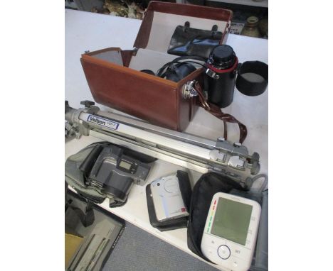 A leather case of Canon lenses, a Velbon tripod stand, an Olympus handheld Superzoom, a Fuji Film Fine Pix 6800 zoom digital 