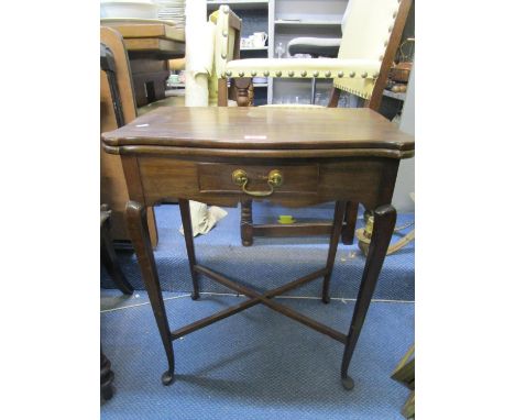 An Edwardian walnut swivel and folding top card table with single drawer on cabriole legs, united by cross stretchers and pad