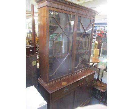 An Edwardian mahogany bookcase cabinet, dentil moulded cornice above twin astrigal glazed doors and internal wood shelving, t