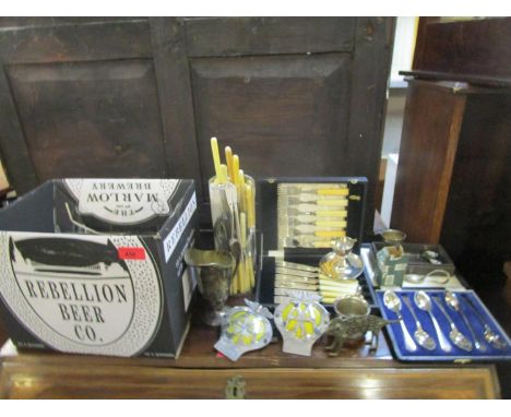 A mixed lot of silver plate and other items to include cased sets, assorted flatware, two AA badges and other items 