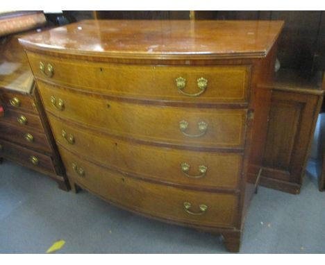 An early 19th century walnut bow fronted chest of four graduated drawers standing on bracket shaped feet 39 3/4" H x 46" W 