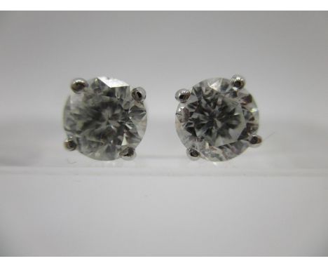 A pair of 14K white gold diamond earrings approximately 1.34ct total, in claw settings, 14k mark to butterfly. 