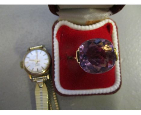 A gold coloured metal ring set with a purple cabochon, stamped 750 and a Camy gold plated ladies watch 