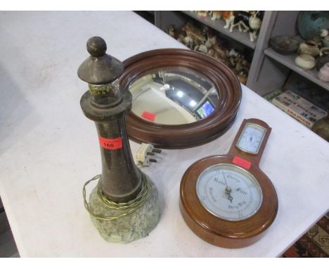 A Cornish stone and marble lamp in the form of a lighthouse, together with a circular mahogany wall mirror and a mid 20th cen