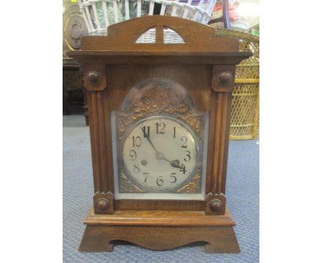 An early 20th century oak mantle clock having a silvered dial surrounded by gilt metal spandrelsLocation: 11:1 
