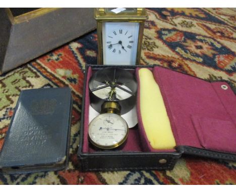 A five window carriage clock with key and enamelled dial, a vintage Post Office savings tin and a Negretti and Sambra air met