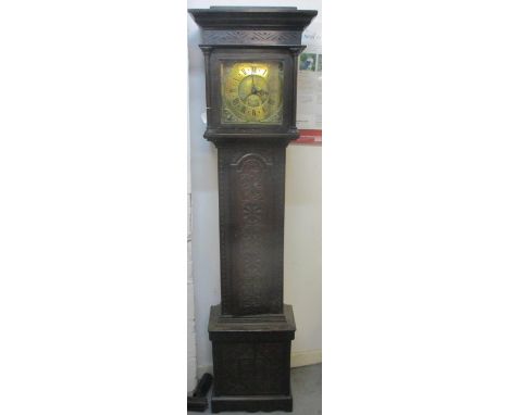 An early 18th century and later longcase clock in a carved oak case. The brass dial having date chapter ring. Roman numerals 