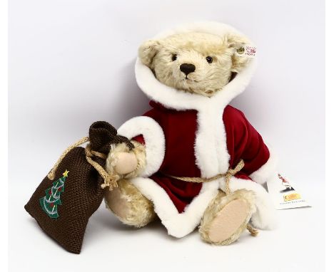 Nikolaus-Teddy, Steiff. Original bekleidet, mit Knopf, Fahne und Schild. Unbespielt. L. 32 cm.